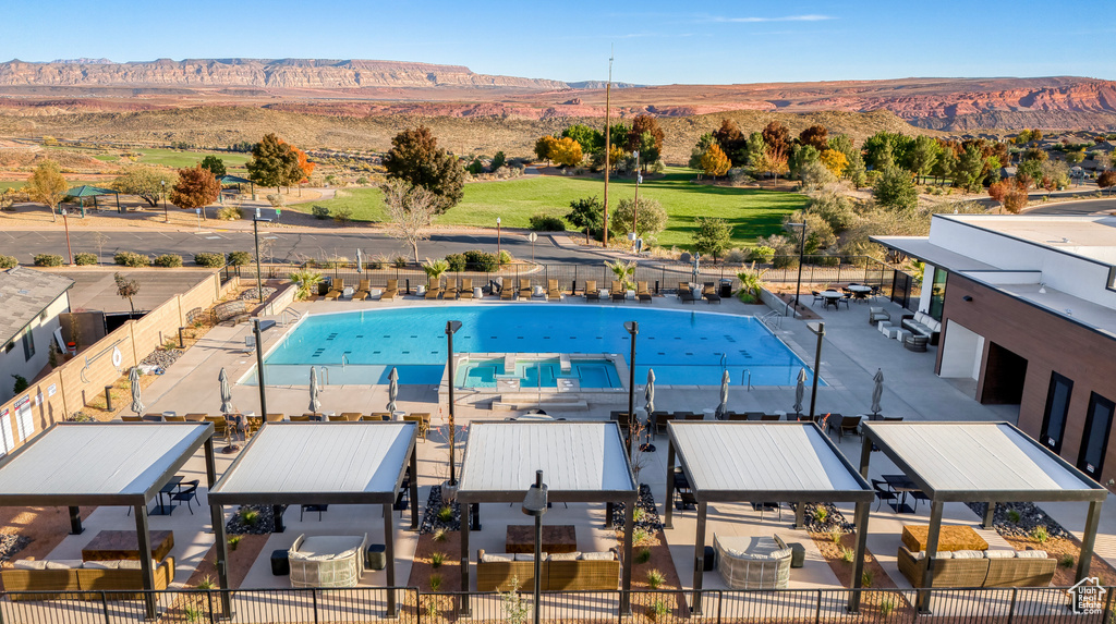 View of pool featuring a mountain view and a gazebo