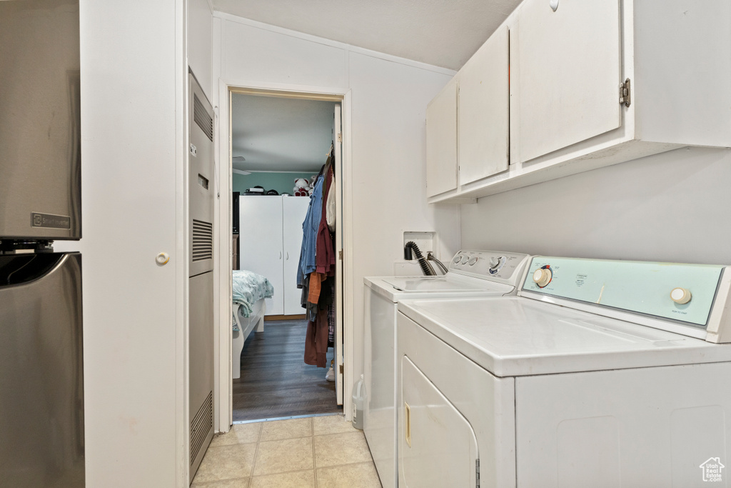 Laundry room featuring cabinet space and independent washer and dryer
