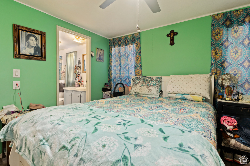 Bedroom with crown molding, connected bathroom, and ceiling fan