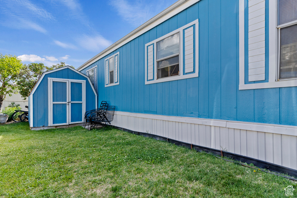 View of property exterior featuring a lawn