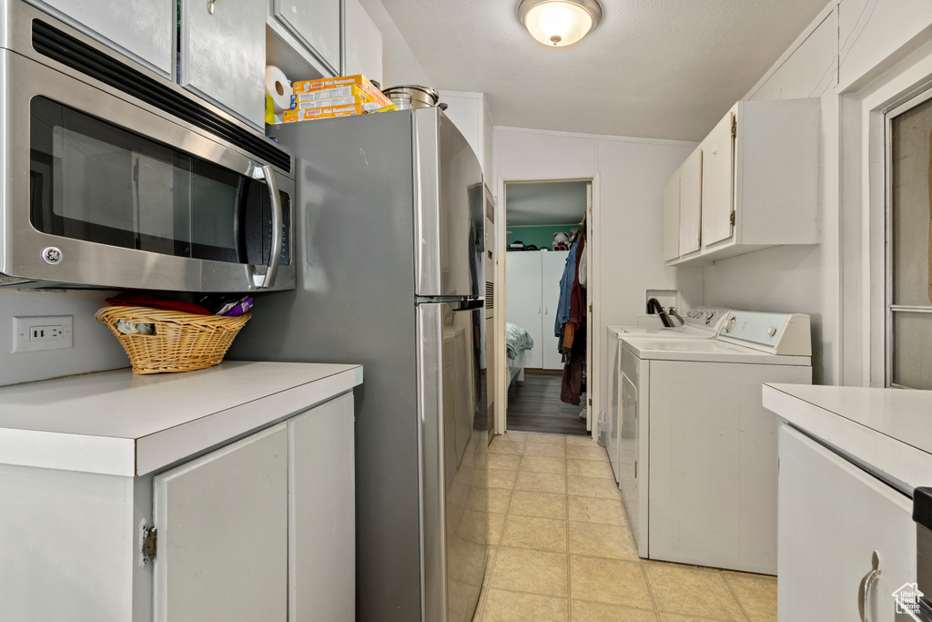Washroom with washing machine and dryer and cabinet space
