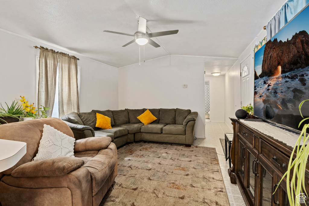 Living area with ceiling fan and vaulted ceiling