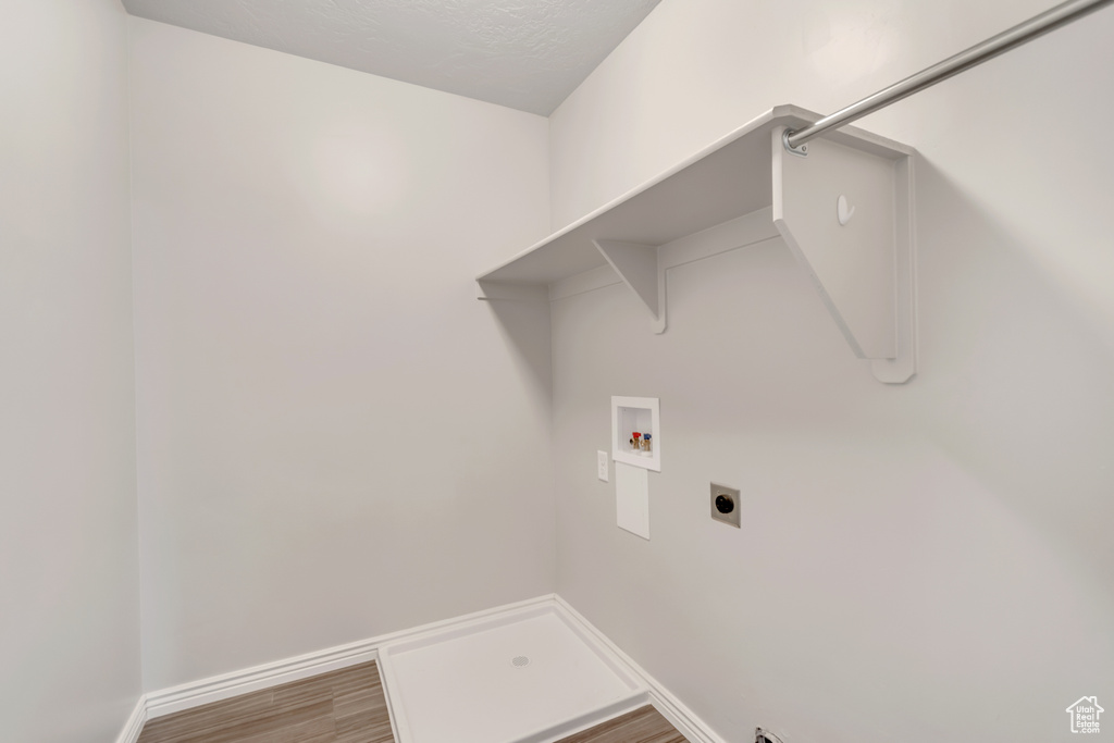 Laundry area featuring washer hookup, hookup for an electric dryer, and wood finished floors
