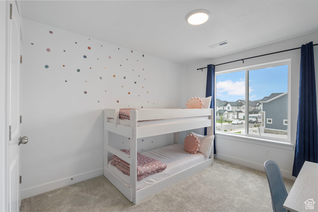 Carpeted bedroom featuring baseboards