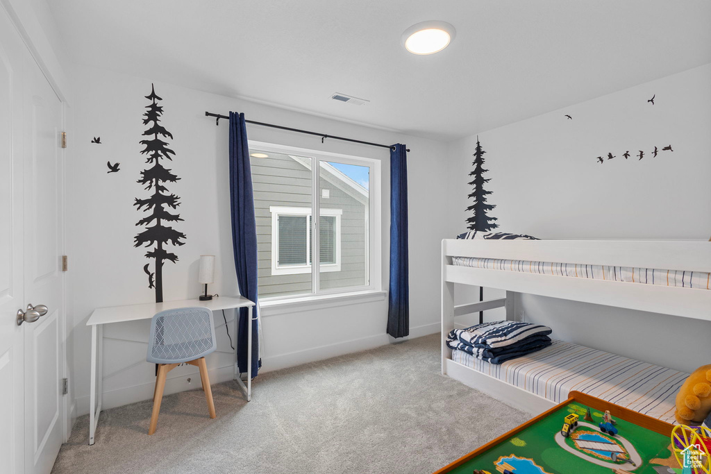 Carpeted bedroom with baseboards