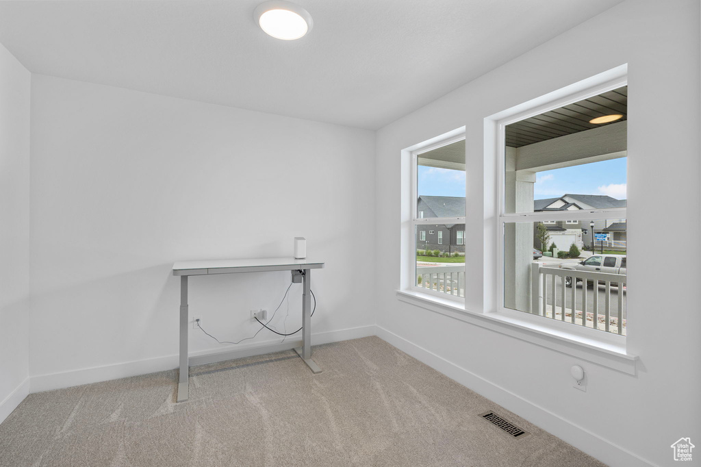 Carpeted empty room with baseboards