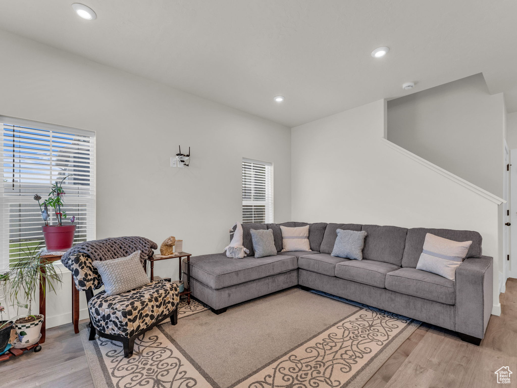 Living room with wood finished floors, recessed lighting, and baseboards