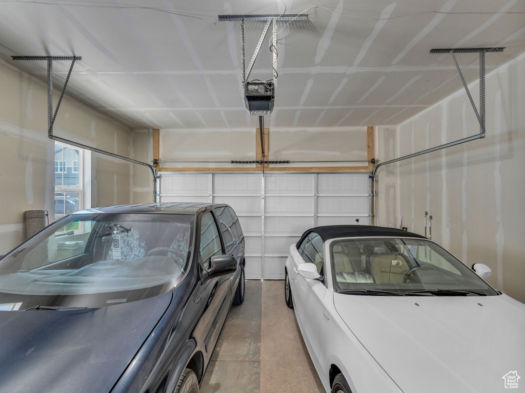 Garage featuring a garage door opener