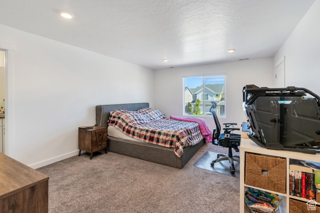 Carpeted bedroom with recessed lighting and baseboards