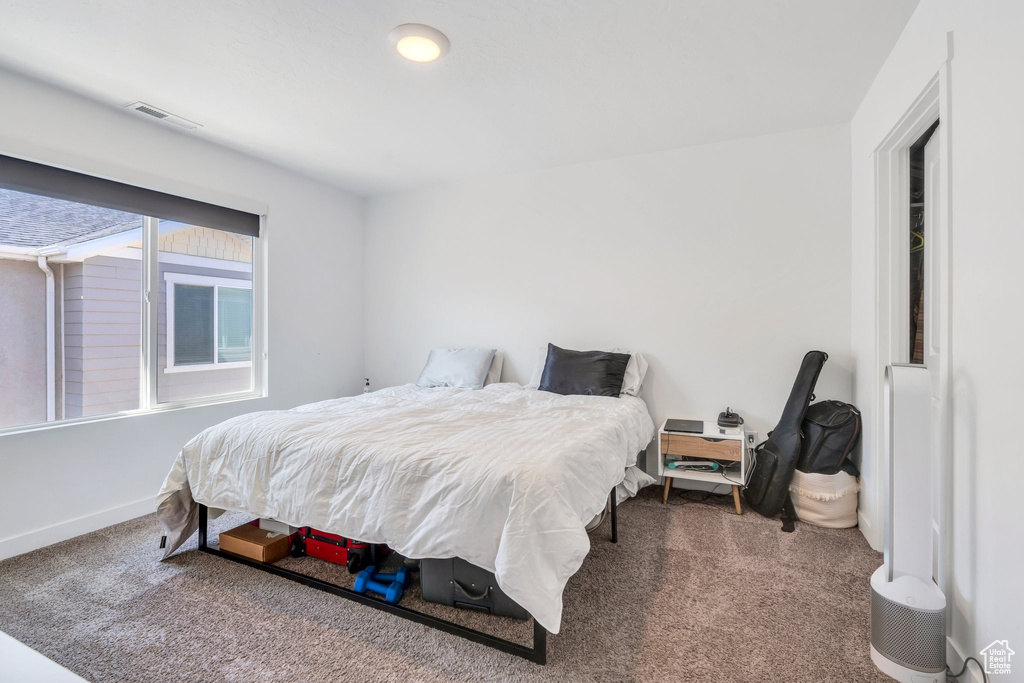 Bedroom featuring carpet floors and baseboards