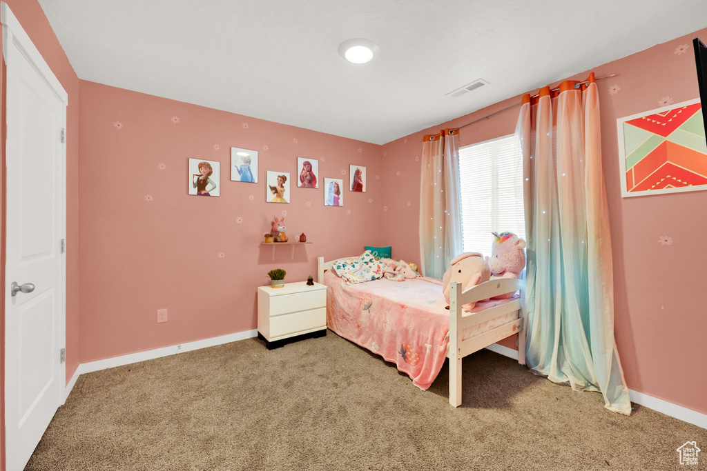 Carpeted bedroom with baseboards