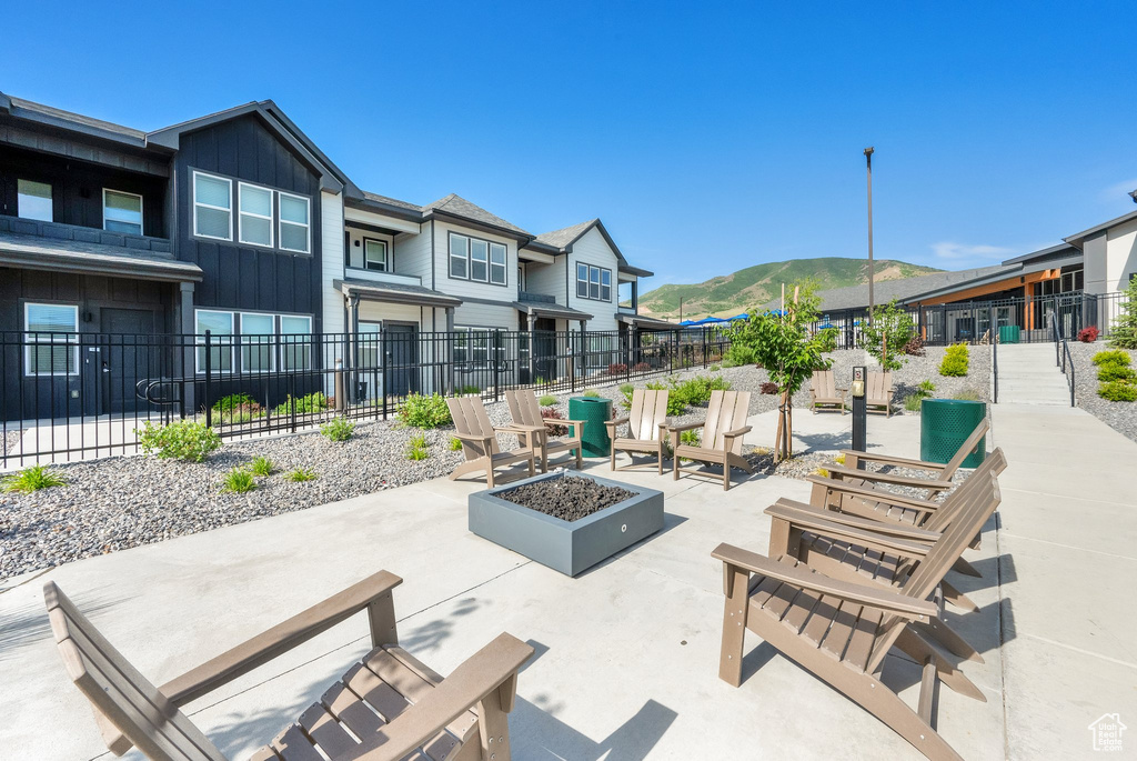 View of community featuring a mountain view, a patio, and an outdoor fire pit