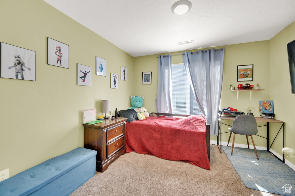 Bedroom featuring carpet and baseboards