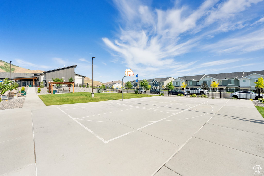 View of vehicle parking featuring a residential view and community basketball court
