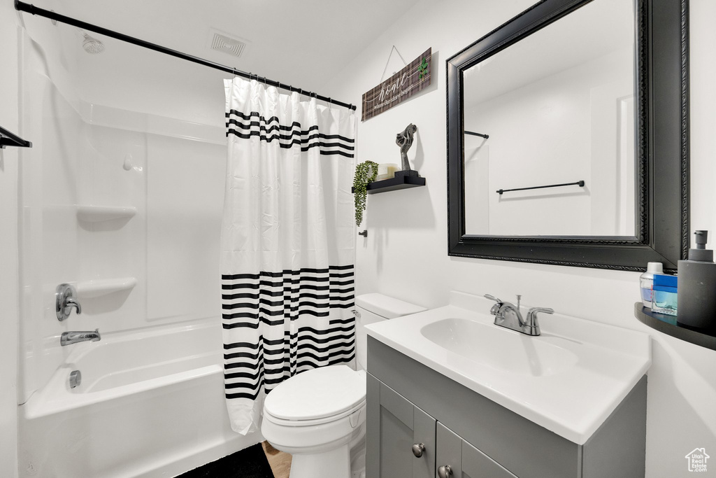 Full bath featuring vanity, toilet, and shower / bath combo