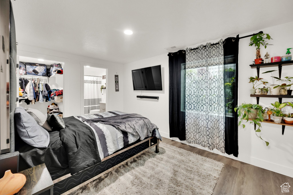 Bedroom with wood finished floors, baseboards, and recessed lighting