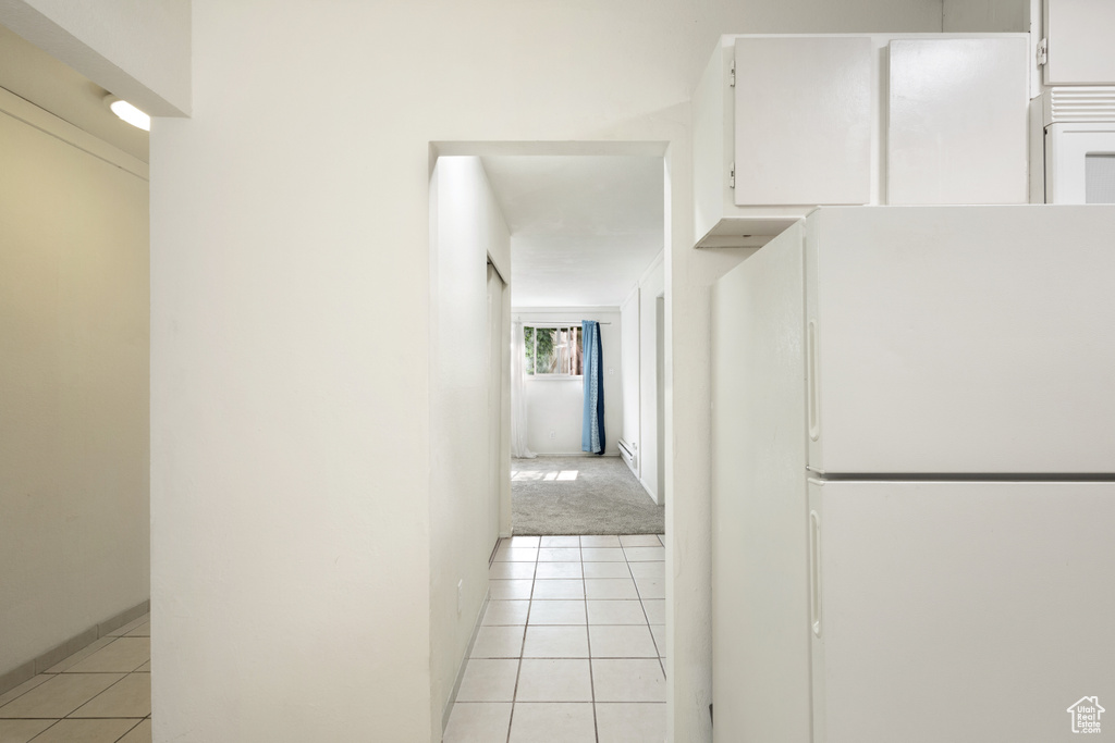 Corridor featuring light tile patterned floors