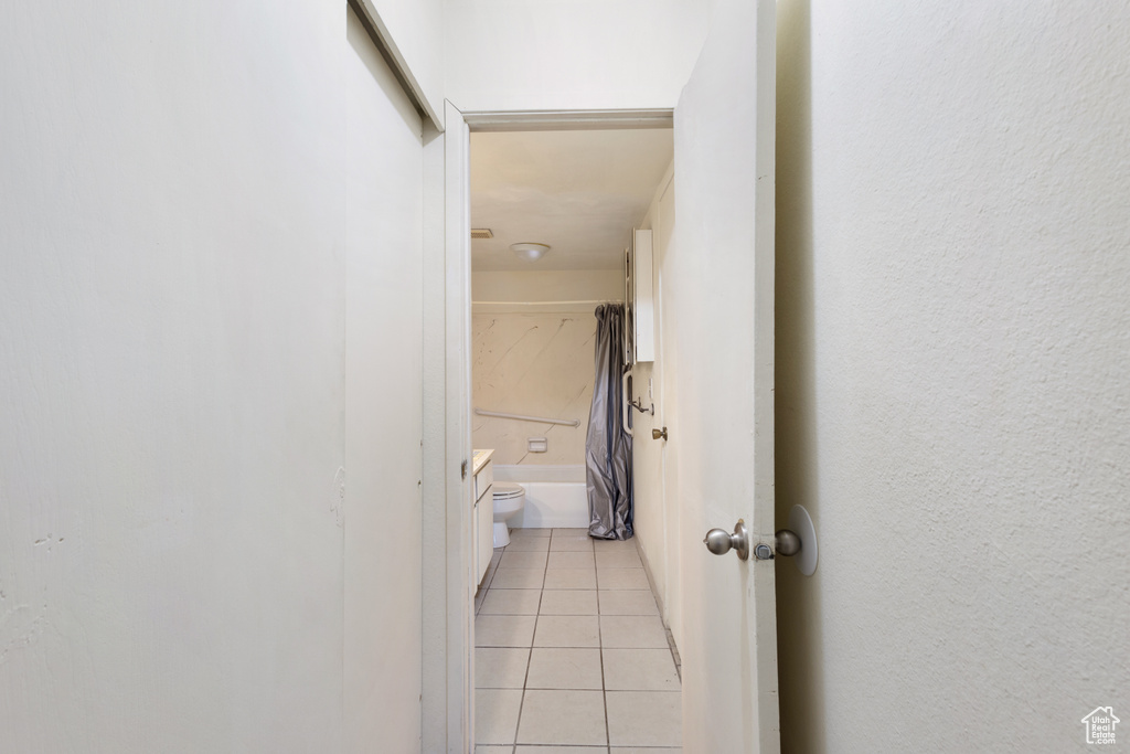 Hall featuring light tile patterned floors