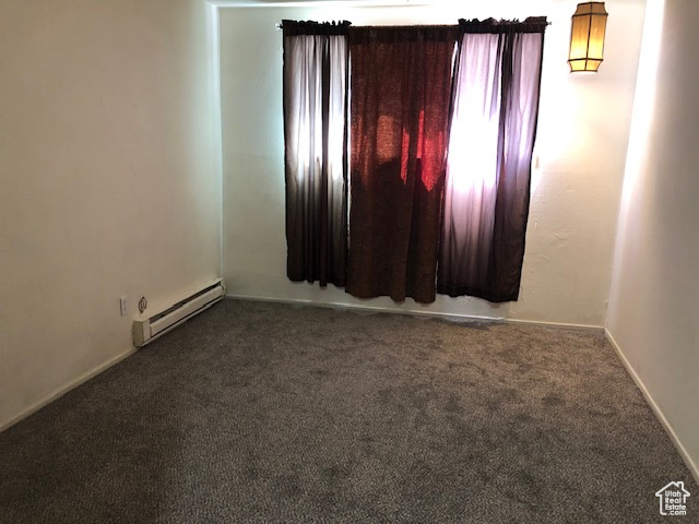 Unfurnished room with a baseboard radiator, carpet, and baseboards