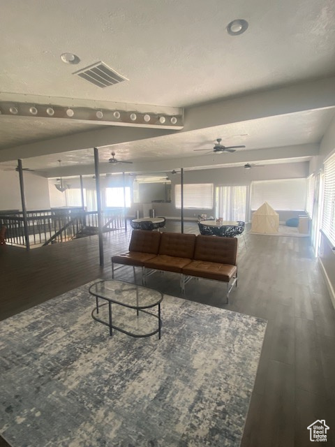 Living room featuring ceiling fan and wood finished floors