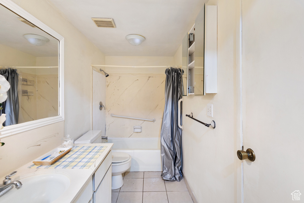 Bathroom with vanity, toilet, shower / tub combo with curtain, and tile patterned flooring