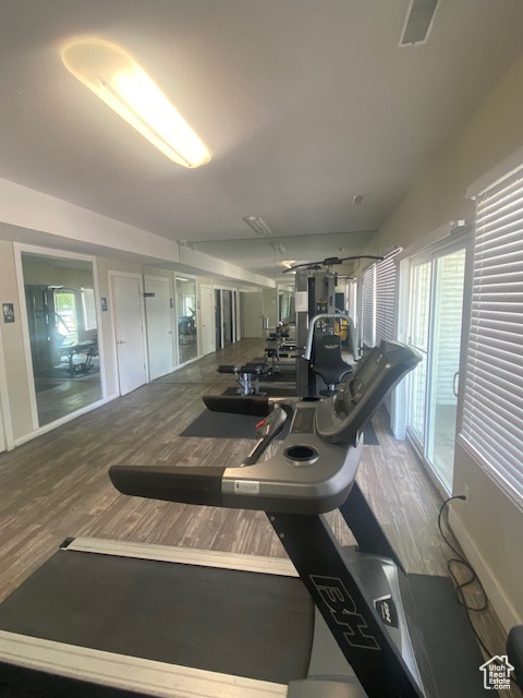 Exercise room featuring wood finished floors