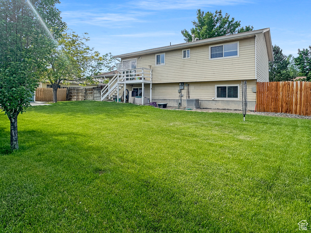 Rear view of property featuring stairway, a deck, and central air condition unit