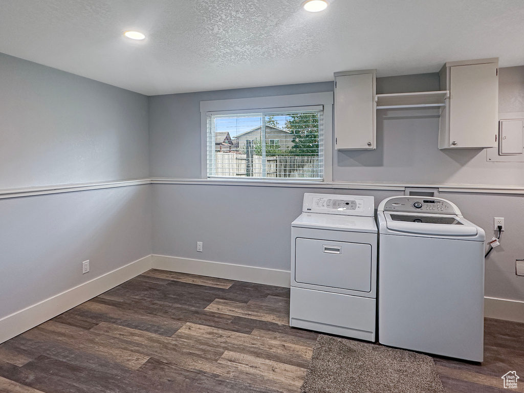 Laundry room with cabinet space, washer and clothes dryer, baseboards, dark wood-style floors, and recessed lighting