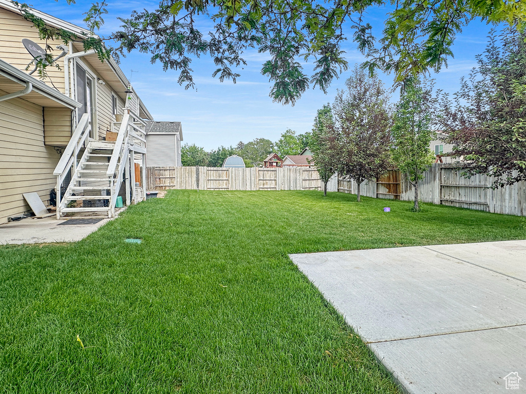View of yard featuring stairs and a patio area