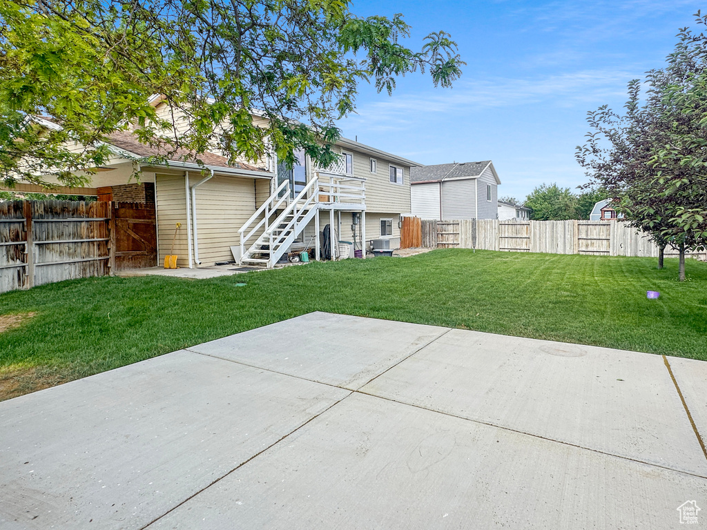 Rear view of house with stairway and a patio