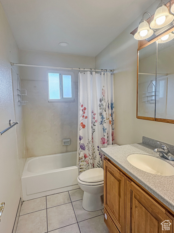 Bathroom with tile patterned flooring, shower / tub combo, vanity, and toilet