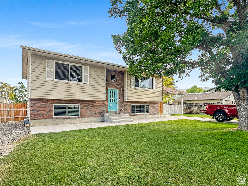 Bi-level home with brick siding and entry steps
