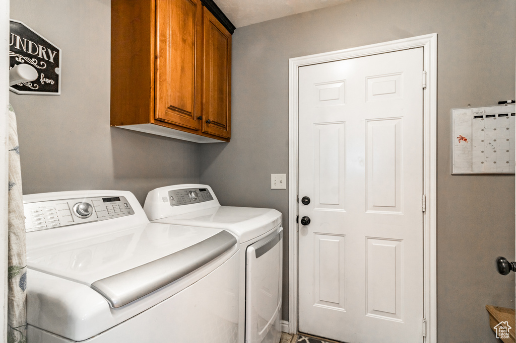 Laundry area featuring cabinet space and washer and dryer