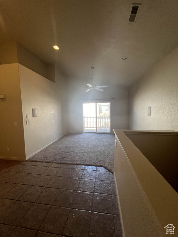Unfurnished room featuring ceiling fan, dark carpet, lofted ceiling, baseboards, and recessed lighting