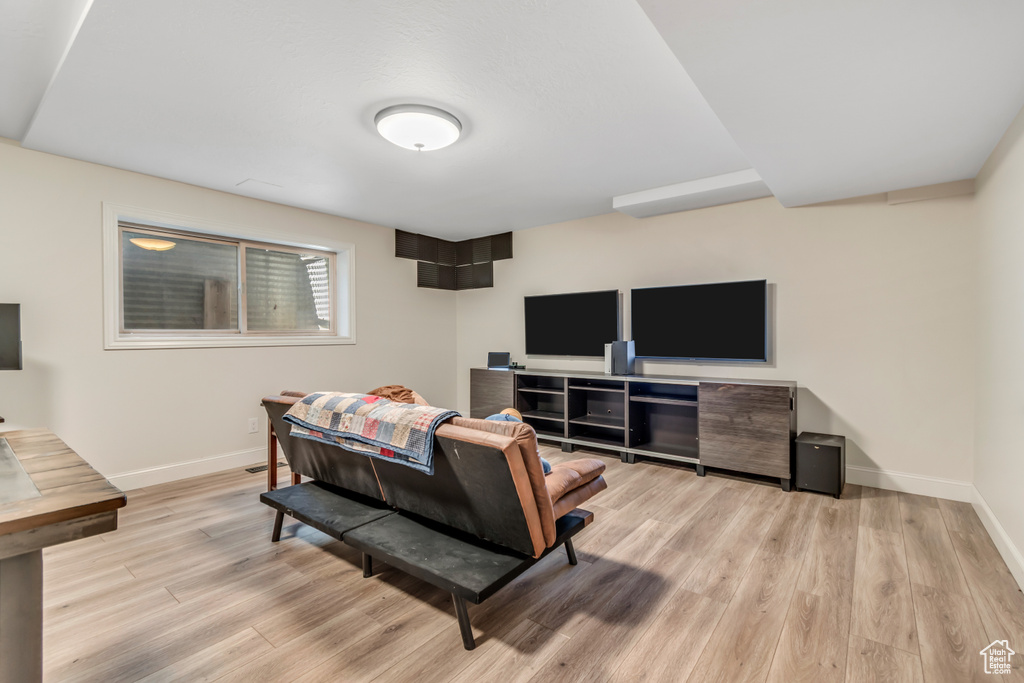 Living room with baseboards and light wood-style floors