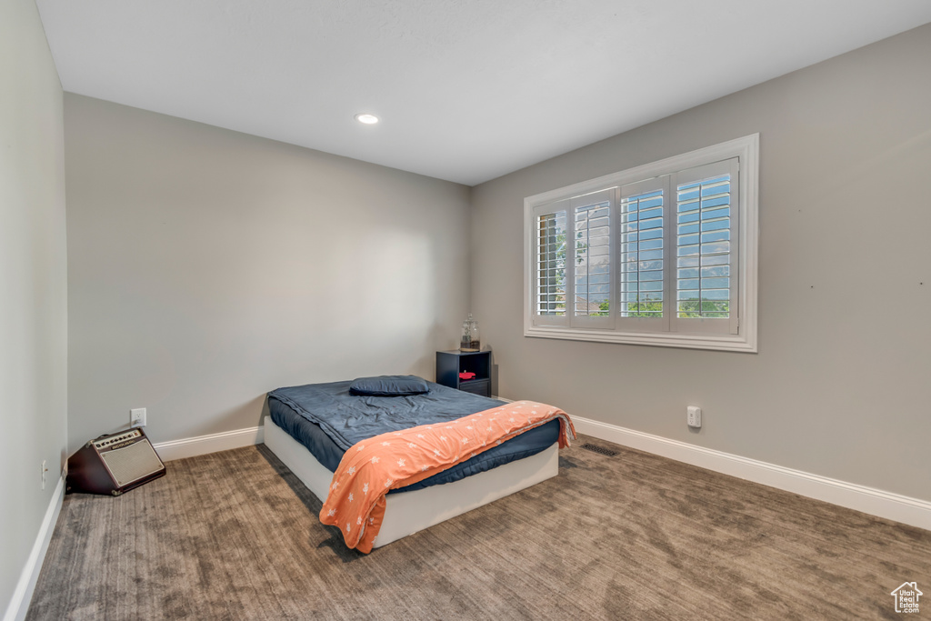 Carpeted bedroom featuring baseboards and recessed lighting