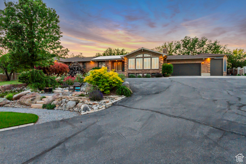 View of front of property featuring an attached garage and driveway
