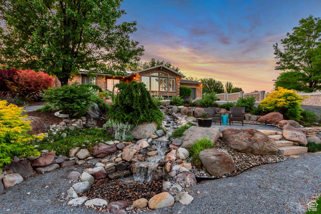 Yard at dusk featuring a patio area