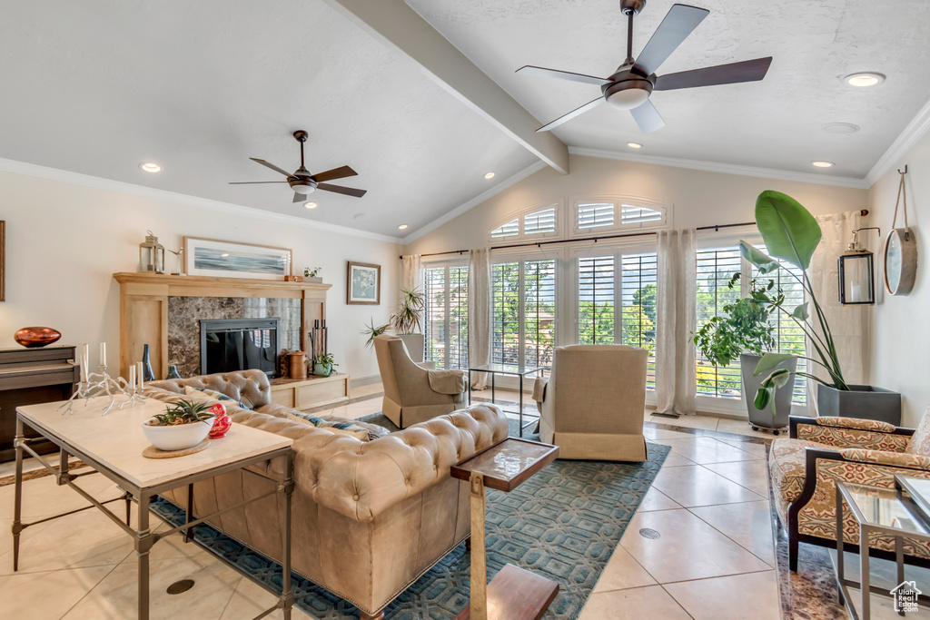 Tiled living area featuring a ceiling fan, a high end fireplace, recessed lighting, and ornamental molding