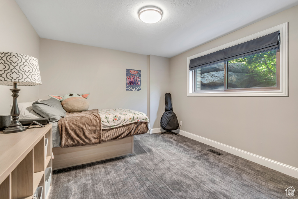 Carpeted bedroom featuring baseboards
