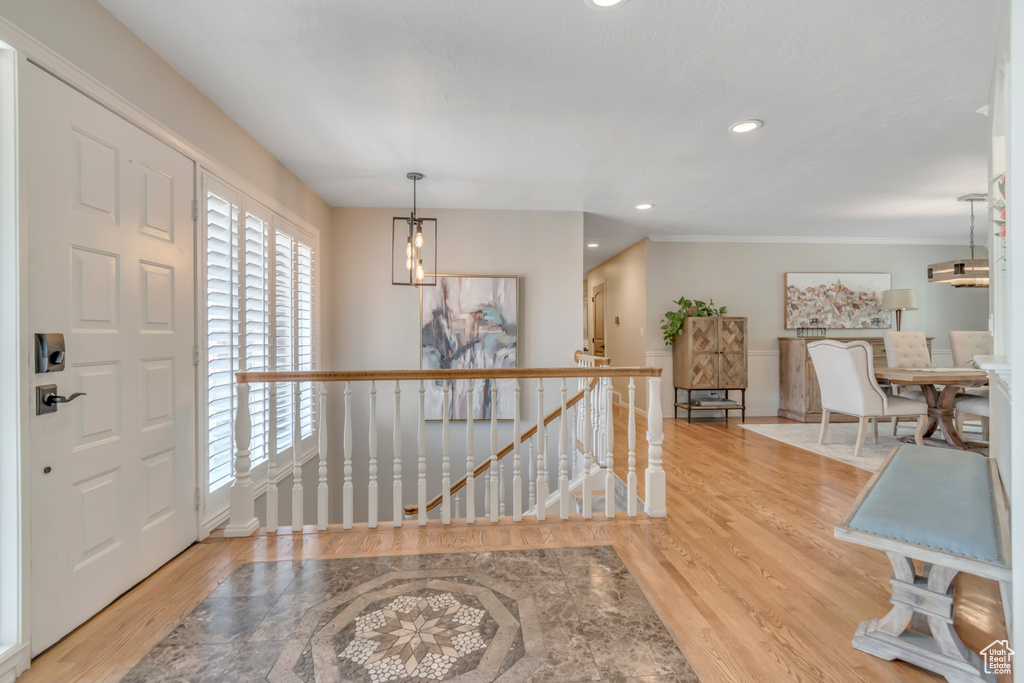 Foyer entrance with wood finished floors, recessed lighting, and baseboards