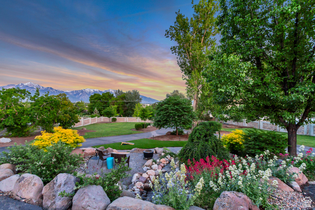 Yard at dusk featuring a mountain view