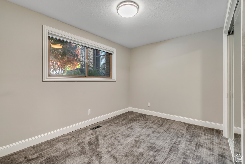 Spare room with baseboards and carpet floors