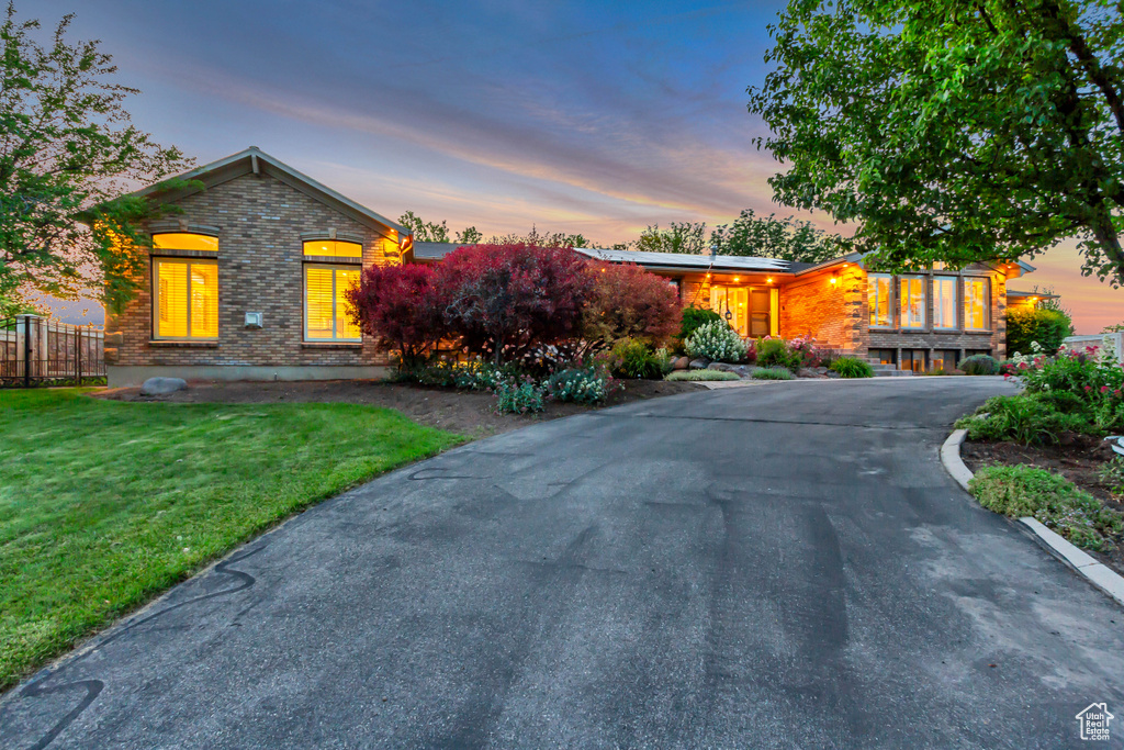 View of front of house featuring driveway and brick siding
