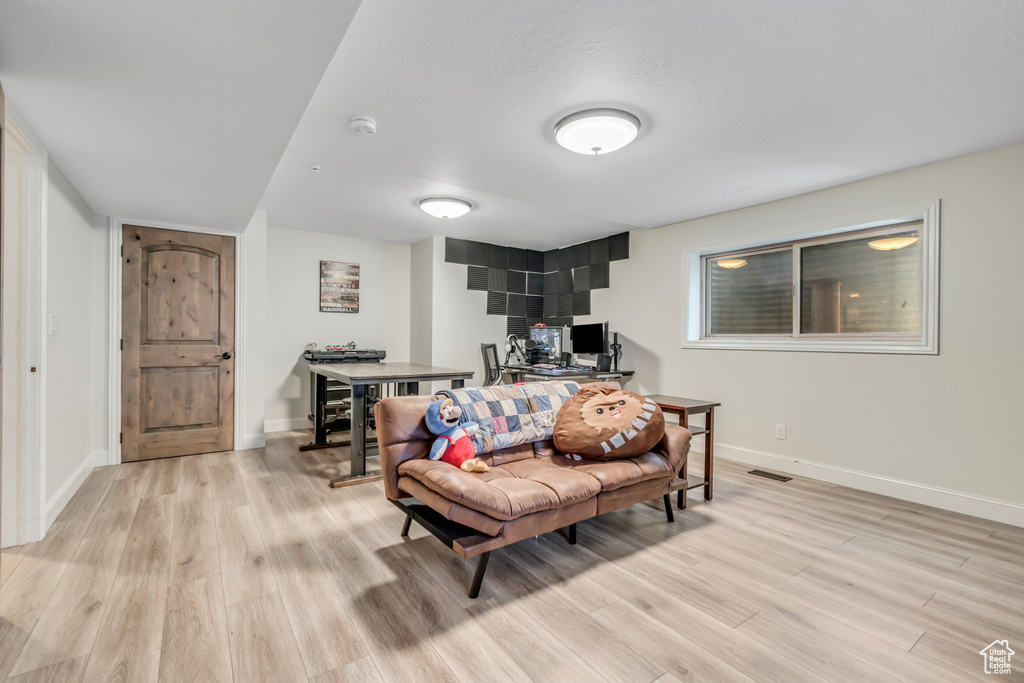 Living room with light wood-style flooring and baseboards