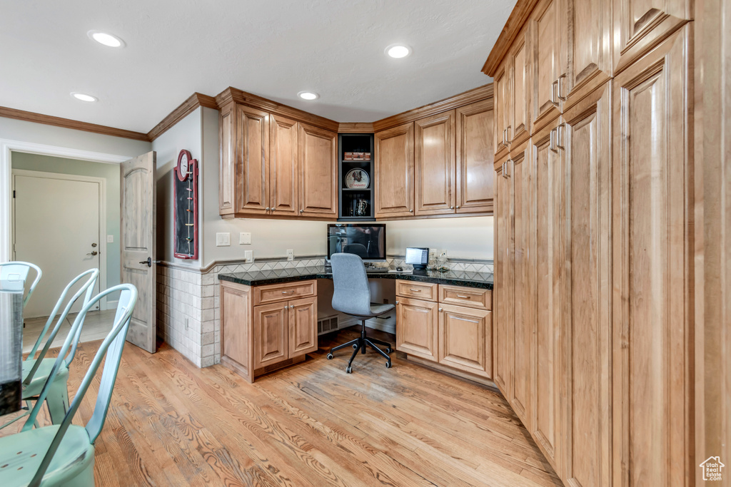 Office with built in study area, recessed lighting, light wood-type flooring, and crown molding