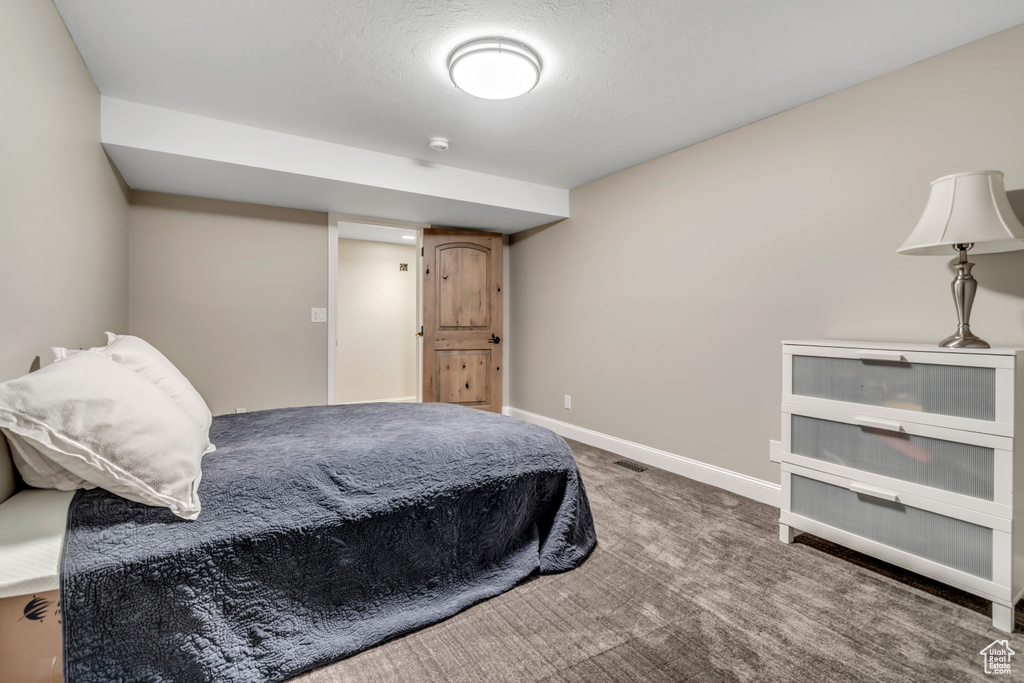 Bedroom featuring carpet floors and baseboards