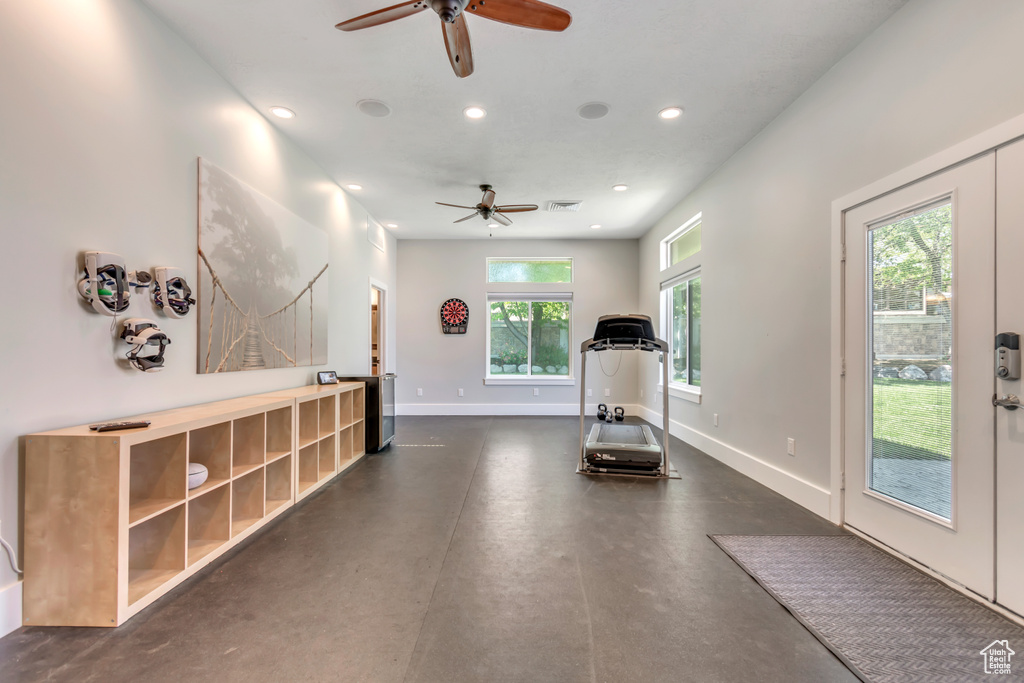Exercise room with a ceiling fan, recessed lighting, and baseboards
