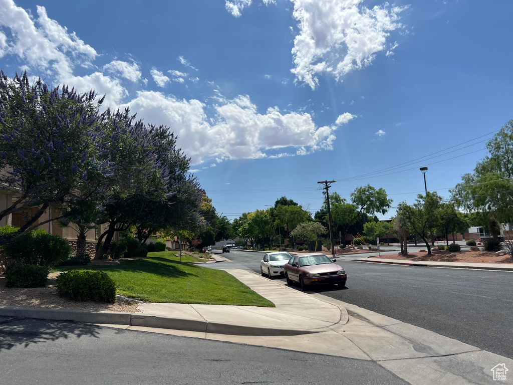View of asphalt street featuring curbs and sidewalks