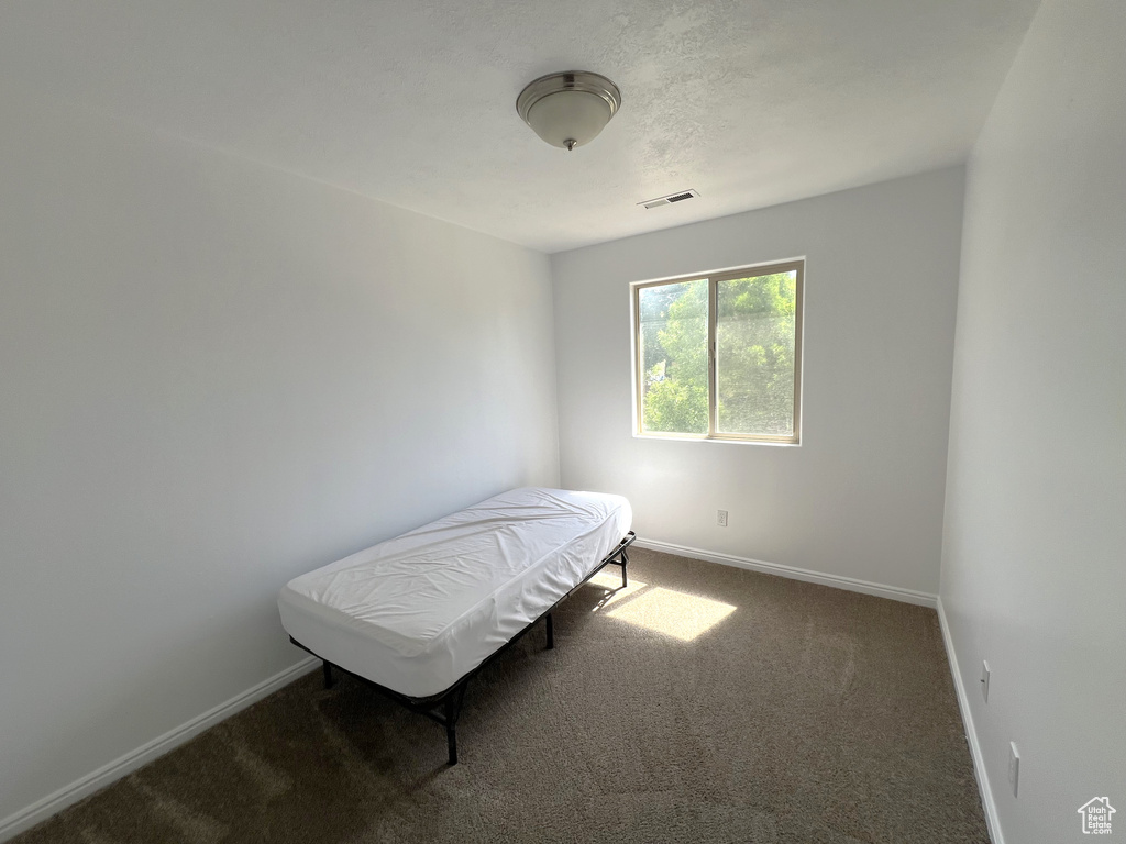 Carpeted bedroom featuring baseboards